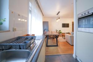 a kitchen with a sink and a stove top oven at Cocon tout chaud - Pour couple avec ou sans bébé in Brussels +15 photos