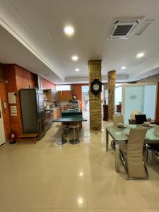 a large room with tables and chairs and a clock at IY Loft 5 - Spacious Loft in the Old Town in Valencia