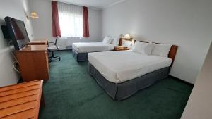 Postel nebo postele na pokoji v ubytování Hotel Diego De Almagro Talca