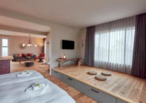 a bedroom with a large bed and a living room at Villa Oloo - Vacation STAY 44072v in Karimata