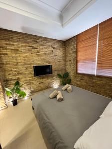a bedroom with a large bed with two towels at IY Loft 5 - Spacious Loft in the Old Town in Valencia