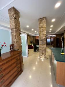 a kitchen with two brick columns in a room at IY Loft 5 - Spacious Loft in the Old Town in Valencia