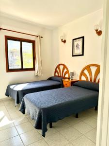 Una habitación de hotel con dos camas y una ventana. en Mangos Mar E, en Puerto Naos