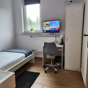 TV a/nebo společenská místnost v ubytování Przytulne pokoje u Julii + 2 fotografie