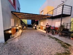 a person sitting on a bike next to a building at Departamento La Morenita in Chilecito