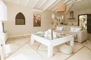 a living room with a couch and a table at La Villa Hibiscus, Saint Martin in Cul de Sac