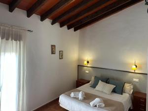 Postel nebo postele na pokoji v ubytování Hostal Camarina