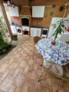 a kitchen with a table with a potted plant on it at Casa Maravilhosa in Praia Grande