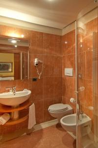 a bathroom with a shower, sink, and mirror at Albergo Celide in Lucca