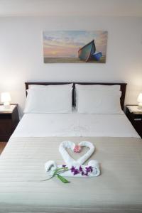 a bed with a heart made out of towels and flowers at Casa Vacanza da Sara in Custonaci