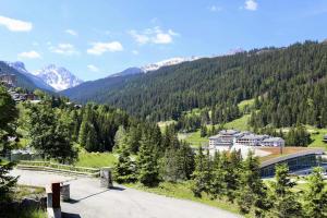 a view of a mountain with a building and trees at Chalets Le Cepe - Beau demi-chalet à l'entrée de Courchevel Moriond MAE-8374 in Courchevel