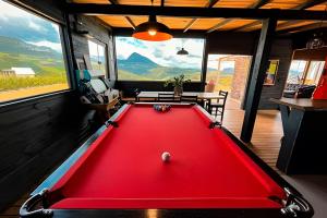 a red pool table in the middle of a room at Refúgio Mirante da Montanha in Alfredo Wagner