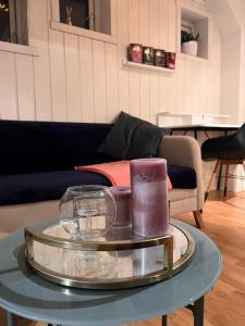 a table with two candles on top of a couch at Cozy 1 bedr apartment close to everything! in Tromsø