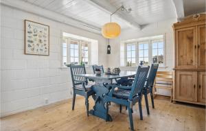 a dining room with a blue table and chairs at 3 Bedroom Gorgeous Home In Blåvand in Blåvand