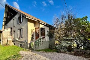 a small white house with a door on the side at Gîte des Randonneurs, jardin & BBQ et borne VE in Gérardmer