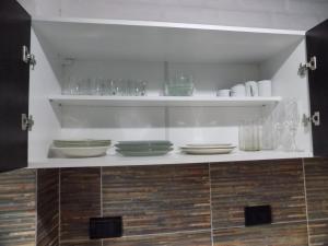 a shelf with bowls and glasses on it at HoltFor in Potrero de los Funes +54 photos