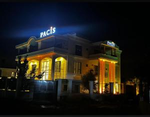 a building with neon signs on it at night at Pacis Antakya in Hatay