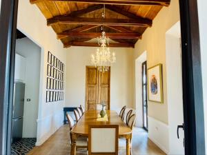 a dining room with a table and chairs and a chandelier at Finca San Mateo - Private Luxury Coffee Estate in Antigua Guatemala in Antigua Guatemala