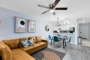 a living room with a couch and a dining room at Oasis 201 - Dune Dream in Titusville