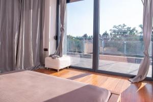 a bedroom with a bed and a large window at Villa Linda in Thessaloniki +27 photos