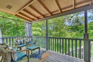 a porch with two chairs and awning at Lakefront Getaway in Bella Vista