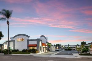 a street with a palm tree and a building at Solara Inn and Suites in Anaheim