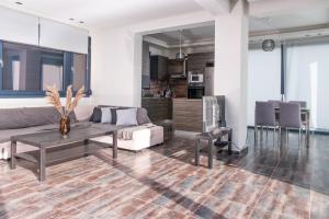 a living room with a couch and a table at Villa Linda in Thessaloniki