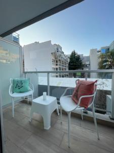 a balcony with two chairs and a table at Depto Monroe 2 in Buenos Aires