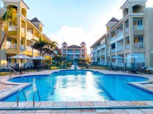 a swimming pool in front of some apartment buildings at Planet Pé na Areia PDD in Aquiraz