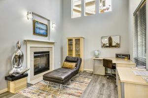 a living room with a leather chair and a desk at 7 Mi to Dwtn Portland - Home with Patio! in Beaverton