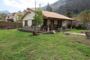 a small house in a field with a yard at casa de campo-arin in Huaran