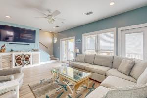 a living room with a couch and a table at Captiva by Meyer Vacation Rentals in Gulf Shores