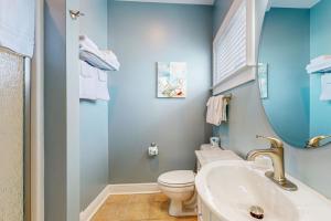 a blue bathroom with a toilet and a sink at Captiva by Meyer Vacation Rentals in Gulf Shores +19 photos