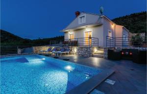 a house with a swimming pool in front of a building at Gorgeous Home In Zaton Veliki in Zaton