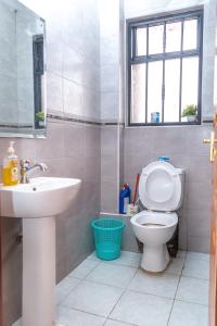 a bathroom with a toilet and a sink at Luxury Two Bedroom Master & Suite Apartment in Nairobi +46 photos