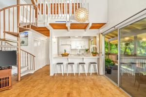 a kitchen with a bar and stools in a house at Beautiful 2 Br 2.5 Ba Condo Golf Course View, Pool, Hot Tub (209AB) in Princeville