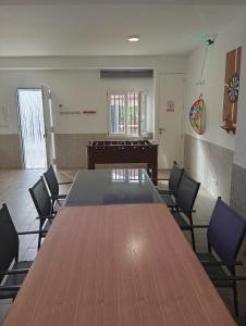 a conference room with a large wooden table and chairs at Villa Turística Miguel in Pulianas +17 photos
