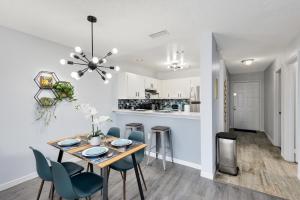 a dining room and kitchen with a table and chairs at Oasis 219 - Amalfi Allure in Titusville
