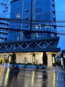 a person riding a motorcycle in front of a building at City Hub 523 in Baguio