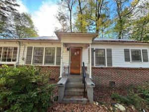 a brick house with a door and stairs in front at Pine Haven Getaway -Crib, Pets Welcome, Perfect for Families & Groups in Birmingham