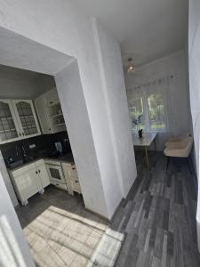a kitchen with white cabinets and a table in it at 1 Apartments Angels okb in Altenburg +14 photos
