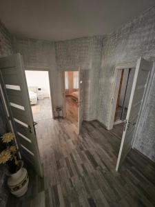 a room with two open doors and a room with at 1 Apartments Angels okb in Altenburg