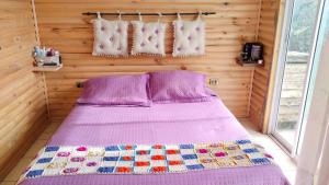 a bedroom with a bed in a wooden room at ALASA Hospedaje in Los Ángeles