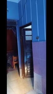 a room with a blue wall and a door to a room at محافظه اسوان جزيره اسوان النجع البحرى in Aswan +3 photos