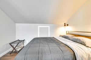 a bedroom with a large bed in a room with white walls at Old Forge Studio: Close to Lakes & Hiking Trails in Old Forge