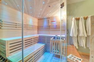 a sauna with wooden walls and a glass shower stall at Spacious Old Forge Condo w/ Patio & Fire Pit! in Old Forge +27 photos
