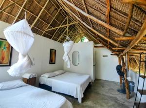 Llit o llits en una habitació de Hotel Jasayma dentro del Parque Tayrona