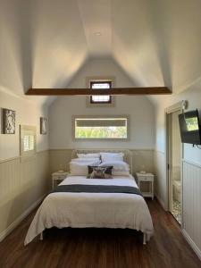 a bedroom with a large bed and a window at Tarra by the Tides in Tarraville