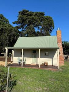 a small white house with a green roof at Tarra by the Tides in Tarraville +19 photos