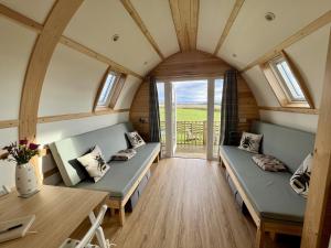 a tiny house with two beds and a table at Sunnybank by Wigwam Holidays in Reston